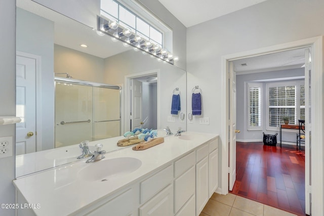 bathroom featuring vanity, a shower with door, and tile patterned floors