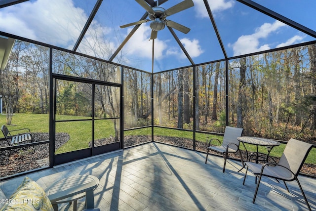 unfurnished sunroom with ceiling fan and plenty of natural light