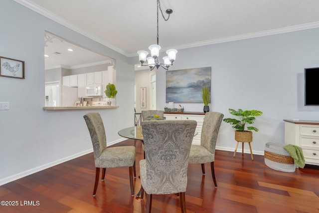 dining room with dark wood-type flooring, ornamental molding, and a notable chandelier