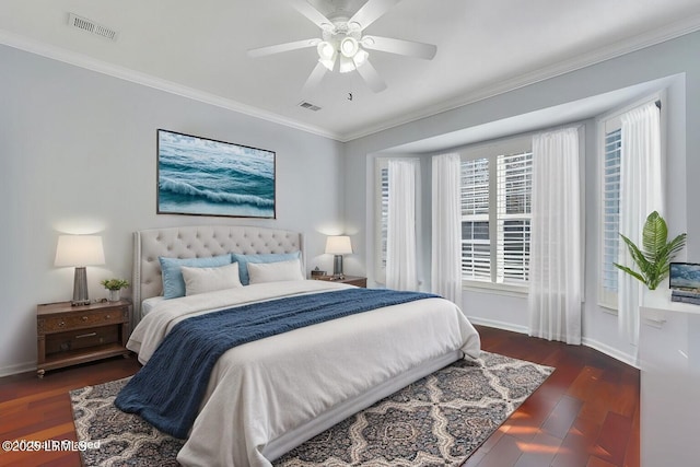 bedroom with crown molding, ceiling fan, and dark hardwood / wood-style floors