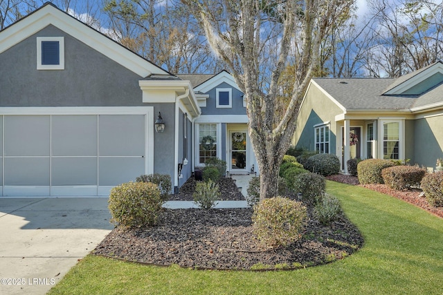 single story home featuring a garage and a front lawn