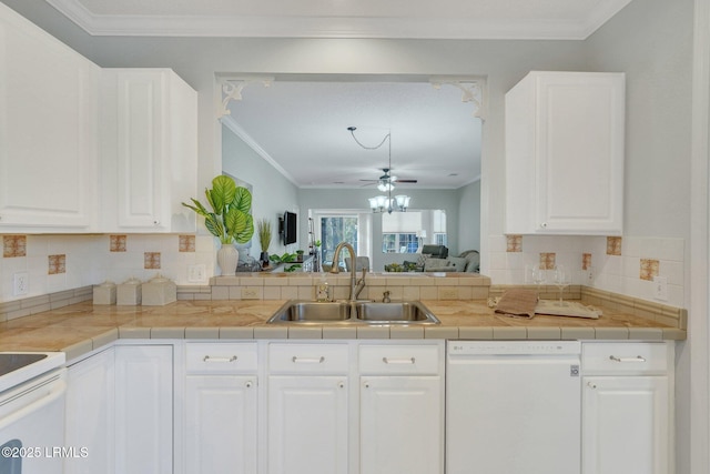 kitchen with sink, crown molding, white appliances, decorative backsplash, and white cabinets