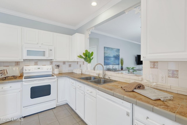 kitchen with sink, tile countertops, light tile patterned floors, white appliances, and white cabinets