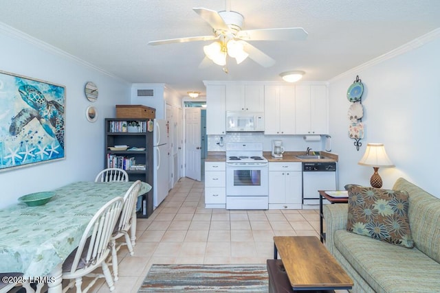 40 Folly Field Rd Unit 202B, Hilton Head Island, SC 29928 - kitchen featuring white cabinetry, light tile patterned floors, white appliances, and ornamental molding