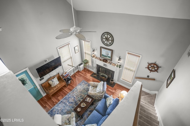 1009 9th St, Port Royal, SC 29935 - living area with high vaulted ceiling, a fireplace, wood finished floors, and a ceiling fan