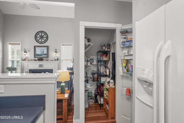 1009 9th St, Port Royal, SC 29935 - kitchen with white fridge with ice dispenser, wood finished floors, a fireplace, and a ceiling fan