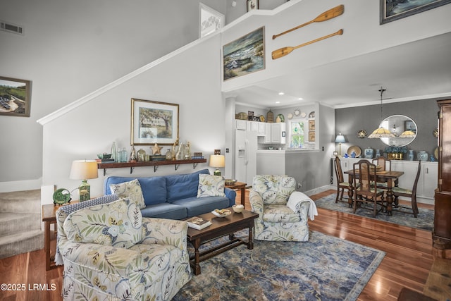 1009 9th St, Port Royal, SC 29935 - living area with wood finished floors, a towering ceiling, and crown molding