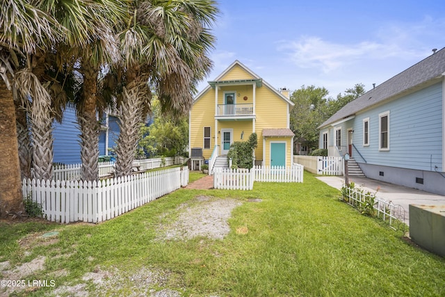 1009 9th St, Port Royal, SC 29935 - view of front of home with a balcony, a fenced front yard, and a chimney