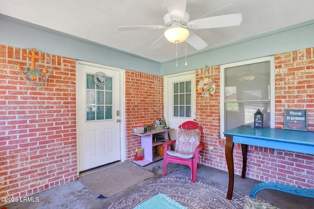 doorway to property with brick siding and ceiling fan
