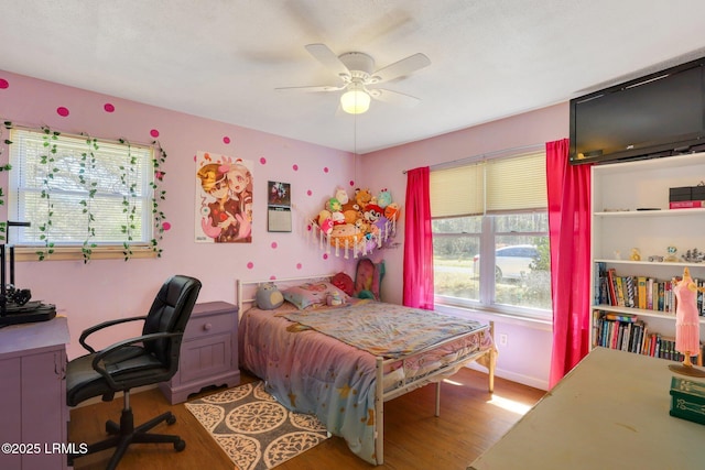 bedroom featuring light wood-style flooring and a ceiling fan