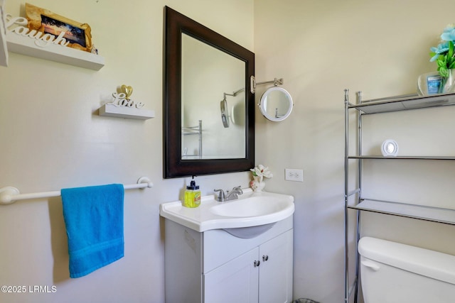 bathroom featuring toilet and vanity