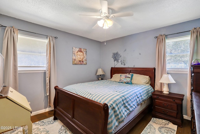 bedroom with baseboards, a textured ceiling, ceiling fan, and wood finished floors