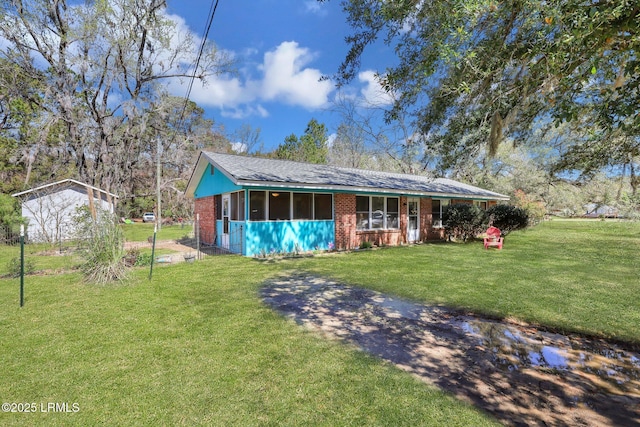 view of front facade featuring a front yard and brick siding