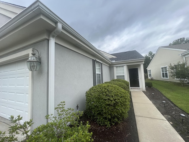 exterior space featuring a garage and stucco siding