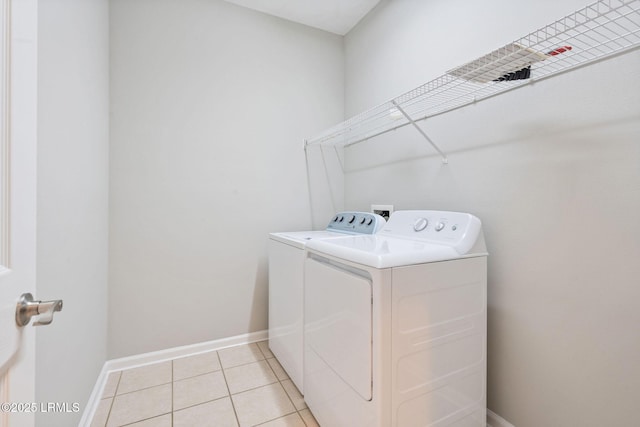 washroom with separate washer and dryer and light tile patterned flooring