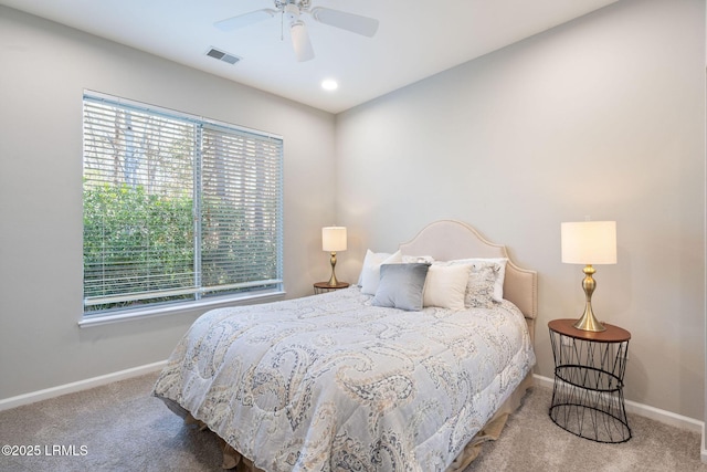 carpeted bedroom with multiple windows and ceiling fan