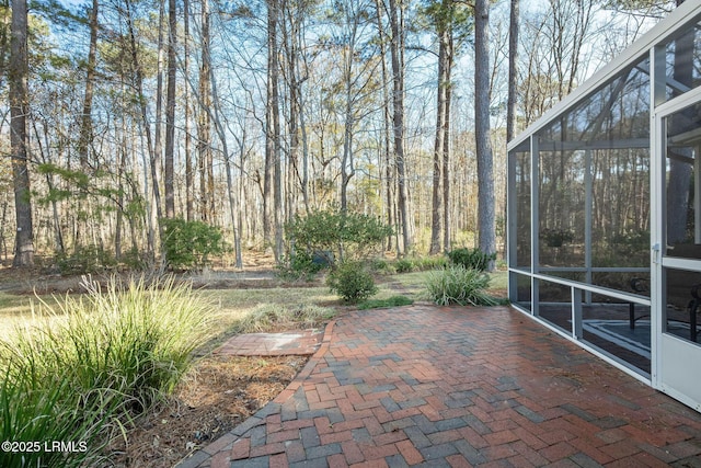 view of patio featuring a lanai