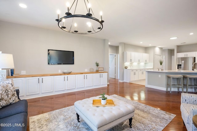 living room with a notable chandelier and light wood-type flooring