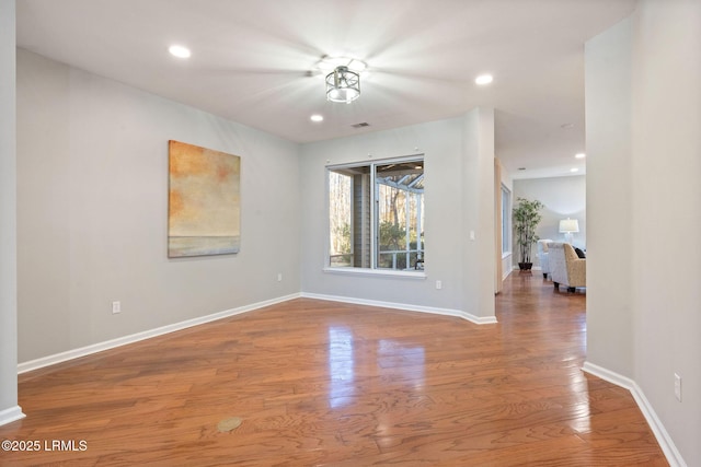 unfurnished room with hardwood / wood-style floors