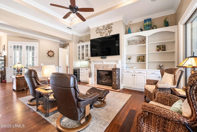 10 Anchor Bay Ct, Bluffton, SC 29910 - living area with beverage cooler, a ceiling fan, crown molding, dark wood-type flooring, and a high end fireplace