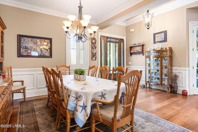 10 Anchor Bay Ct, Bluffton, SC 29910 - dining space featuring a chandelier, wood finished floors, a decorative wall, ornamental molding, and a wainscoted wall