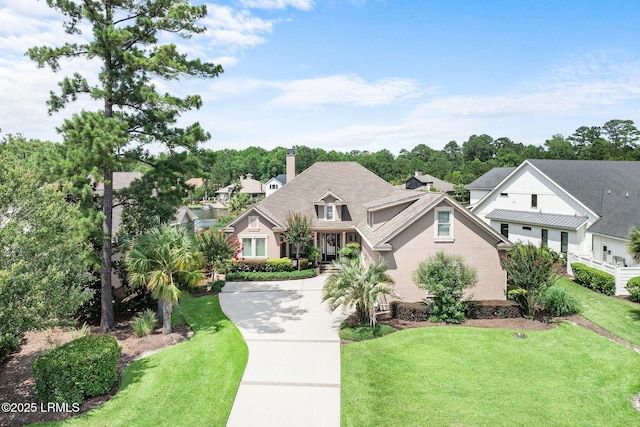 10 Anchor Bay Ct, Bluffton, SC 29910 - view of front of house featuring a front yard, stucco siding, and a chimney