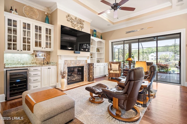 10 Anchor Bay Ct, Bluffton, SC 29910 - living area with wine cooler, crown molding, dark wood finished floors, ceiling fan, and bar