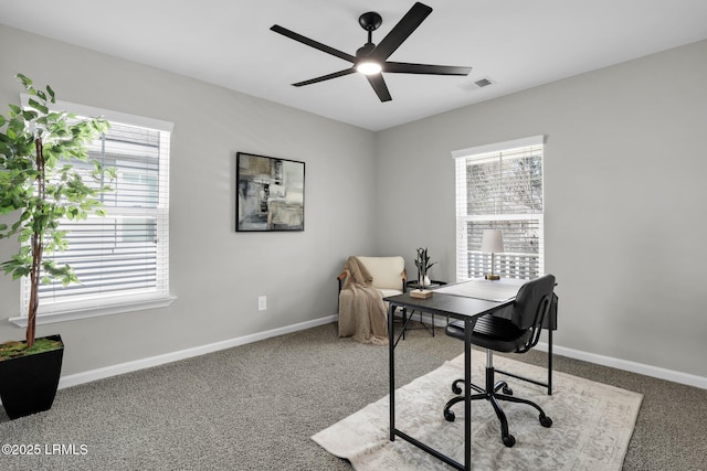 carpeted office space with a wealth of natural light and ceiling fan