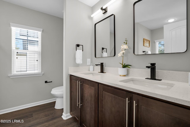 bathroom featuring hardwood / wood-style flooring, vanity, and toilet