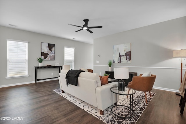 living room featuring ceiling fan and dark hardwood / wood-style floors