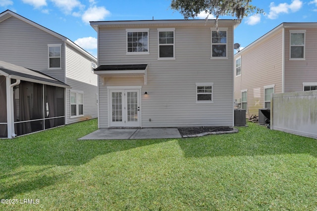 back of property featuring a patio, a lawn, central AC unit, and french doors