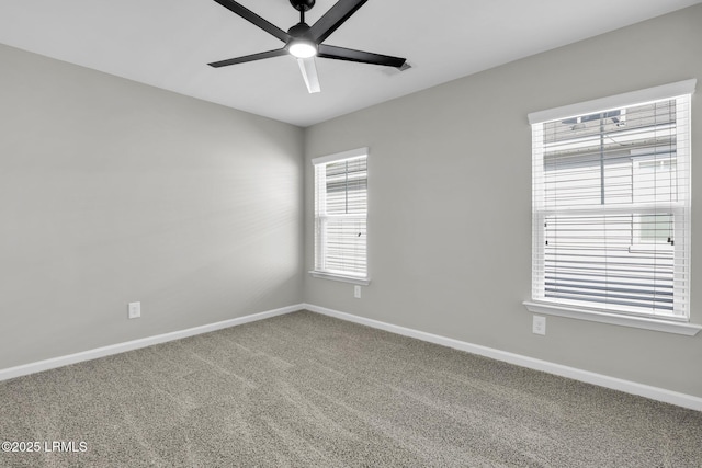 carpeted spare room featuring ceiling fan and a healthy amount of sunlight