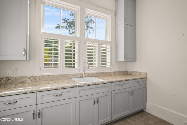1448 Gleasons Landing Dr, Saint Helena Island, SC 29920 - kitchen with baseboards, a sink, tile patterned floors, and a healthy amount of sunlight
