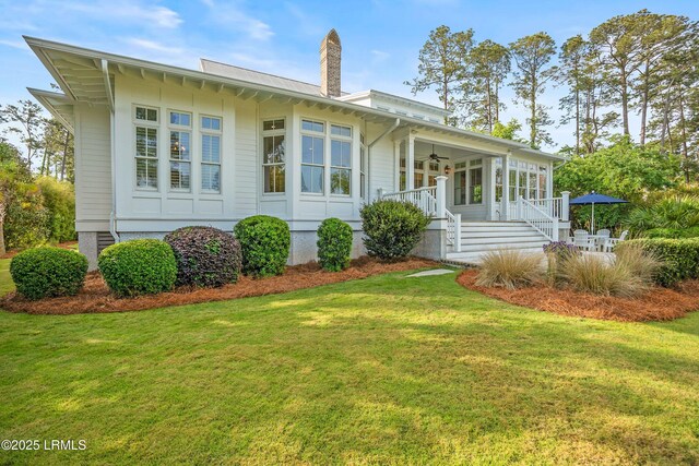 1448 Gleasons Landing Dr, Saint Helena Island, SC 29920 - back of house with a yard, a ceiling fan, a porch, and a chimney