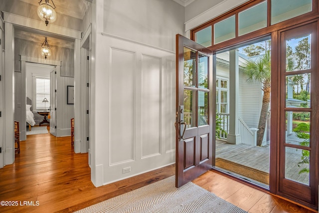 1448 Gleasons Landing Dr, Saint Helena Island, SC 29920 - entryway featuring ornamental molding, a decorative wall, and light wood finished floors