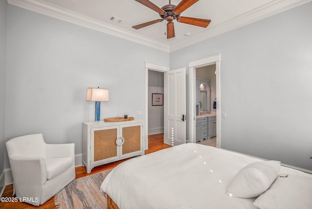 1448 Gleasons Landing Dr, Saint Helena Island, SC 29920 - bedroom with visible vents, ornamental molding, wood finished floors, baseboards, and ensuite bathroom