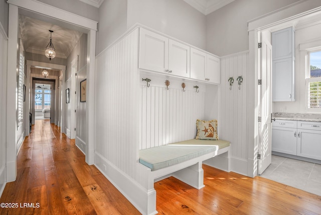 1448 Gleasons Landing Dr, Saint Helena Island, SC 29920 - mudroom featuring crown molding, light wood-style flooring, baseboards, and a healthy amount of sunlight