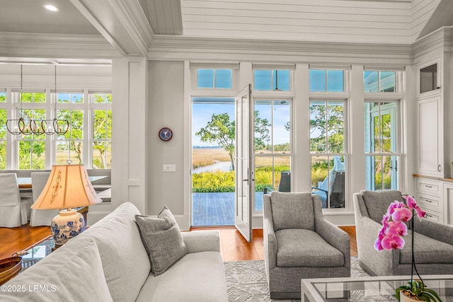 1448 Gleasons Landing Dr, Saint Helena Island, SC 29920 - sunroom / solarium featuring a water view, an inviting chandelier, and french doors