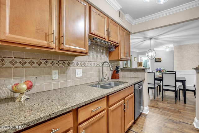 kitchen with visible vents, stainless steel dishwasher, ornamental molding, a sink, and light stone countertops