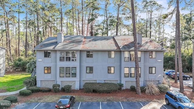 view of building exterior featuring uncovered parking