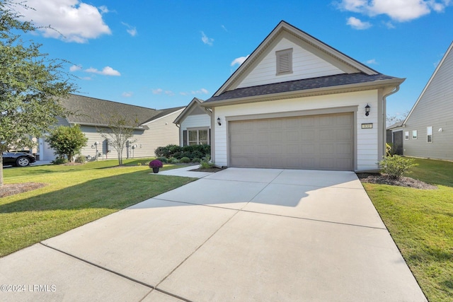 view of front of property with a garage and a front lawn