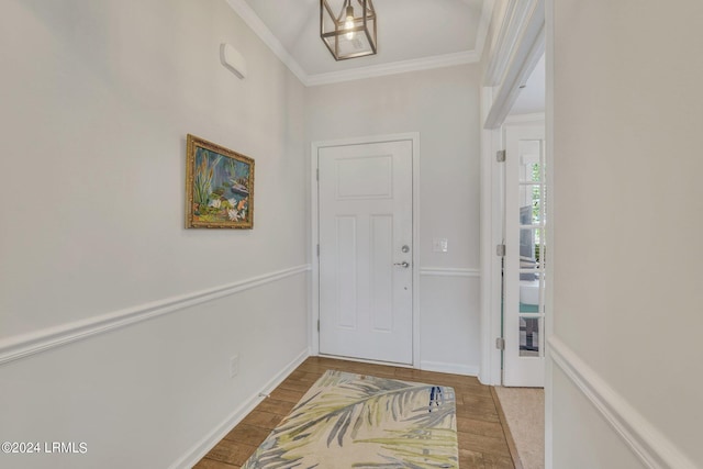 entrance foyer with ornamental molding and light wood-type flooring