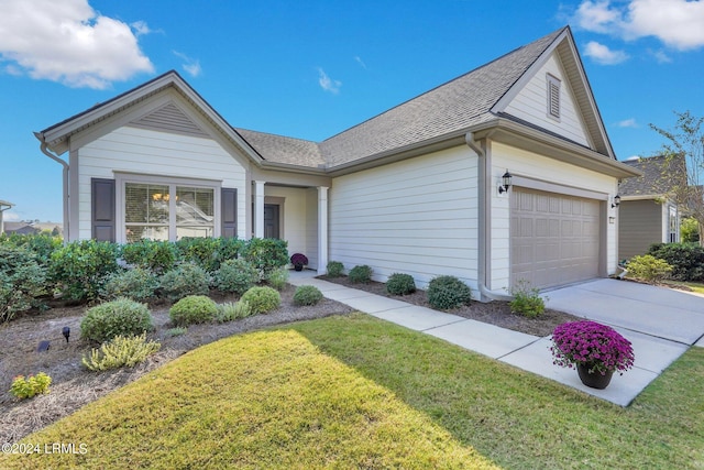 ranch-style house with a garage and a front yard