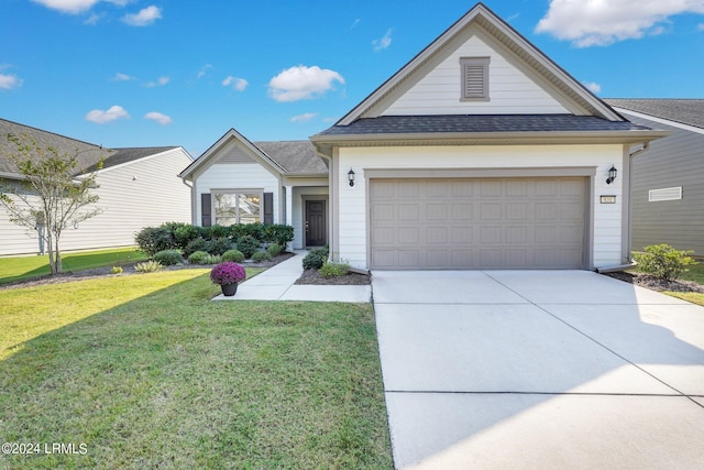 view of front of house with a garage and a front yard