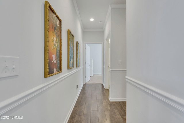 hall with hardwood / wood-style flooring and ornamental molding