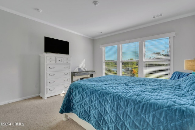 carpeted bedroom with ornamental molding