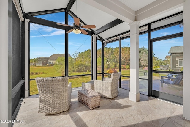 sunroom featuring ceiling fan and beamed ceiling