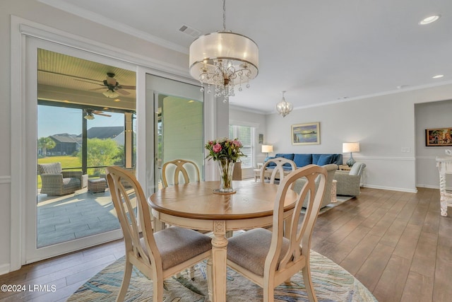 dining room featuring ceiling fan with notable chandelier and ornamental molding