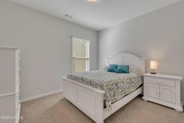 bedroom featuring light colored carpet