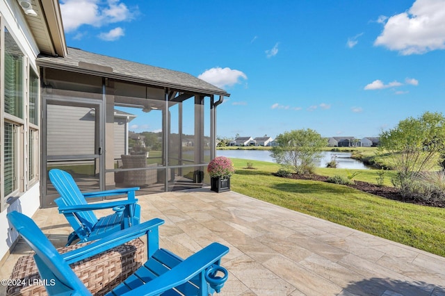 view of patio / terrace featuring a water view and a sunroom